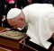 In this photo provided by the Vatican newspaper L'Osservatore Romano, Pope Francis bends to kiss an icon of the Madonna, given to him by Russian President Vladimir Putin, standing beside him, on the occasion of their private audience at the Vatican, Monday, Nov. 25, 2013. Putin and Francis met privately for 35 minutes Monday evening in the pope's private library. (AP Photo/L'Osservatore Romano, ho)