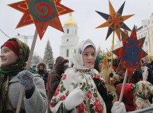 Ukrainians in folk costumes hold symbols of the star of Bethlehem as they celebrate Orthodox Christmas in central Kiev, Ukraine, Saturday, Jan. 7 2017. Orthodox Christians mark their traditional Christmas Day Jan. 7, with many ancient symbolic events. (AP Photo/Efrem Lukatsky)